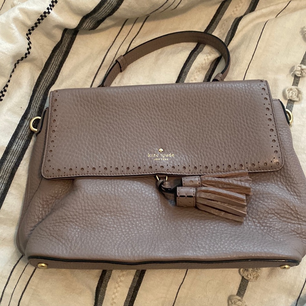 Kate spade handbag.  Small discoloration on back.  Review picture